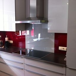 Moderne Küche mit rot lackierter Glasfläche
